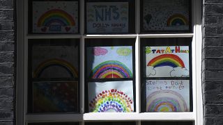 Drawings of rainbows thanking the NHS are attached to a window at 10 Downing Street,