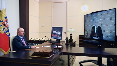 Russian President Vladimir Putin listens to Moscow Mayor Sergei Sobyanin during their meeting via teleconference Wednesday, May 27, 2020