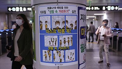 A poster on precautions against the new coronavirus is displayed at a subway station in Seoul, South Korea, Thursday, May 28, 2020.