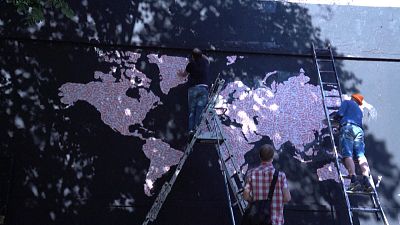 Map of Europe made up of "Fragile" stickers being prepared by street artist Ender