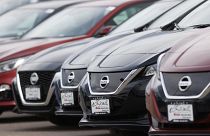 In this Sunday, April 26, 2020, photograph, a long row of unsold 2020 Leaf and Altima sedans sits at a Nissan dealership in Highlands Ranch, Colo. (AP Photo/David Zalubowski)