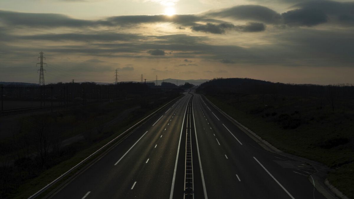 An empty highway is pictured outside Lyon, central France, Sunday, March 22, 2020. (AP Photo/Laurent Cipriani)