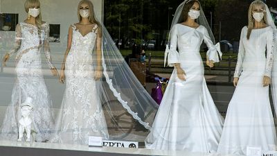 wedding dress store with mannequins wearing face masks