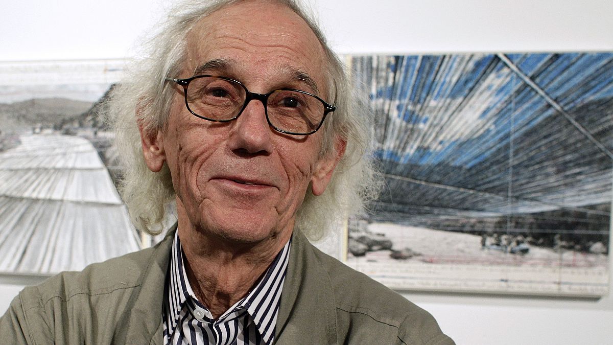 This Jan. 23, 2013 photo shows artist Christo in front of his proposed "Over the River" project at the Metropolitan State University Center for Visual Art in Denver, US.