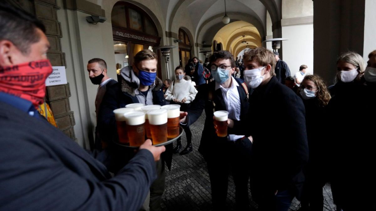 La gente fa la fila per una birra sulla terrazza di un ristorante a Praga, Repubblica Ceca