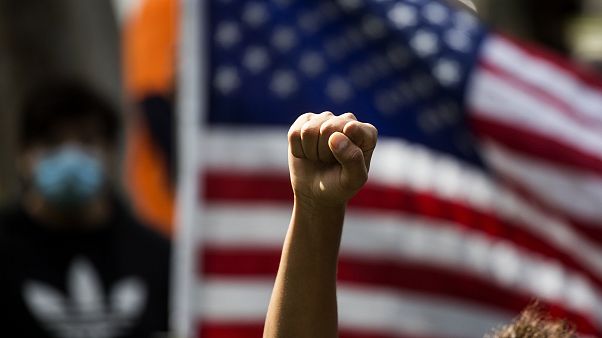 A demonstrator rises his fist during a protest over the death of George Floyd in Minneapolis, A demonstrator rises his fist during a protest over the death of George Floyd in Minneapolis,