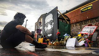 Trevor Rodriquez sits alone at the spot where Floyd died while in police custody, Tuesday June 2, 2020, in Minneapolis.