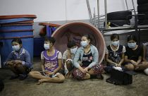 Children and teenagers to be registered by officials during a raid on a shrimp shed in Thailand.