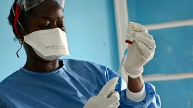 A healthcare worker from the WHO prepares vaccines to give to front line aid workers in the Congo