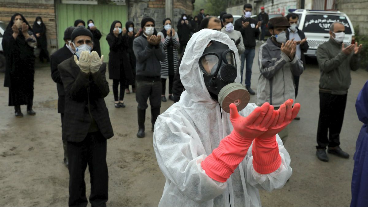 Mourners wearing protective clothing, face masks and gloves, city of Babol, in north of Iran