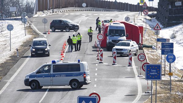 Czech policemen are standing on a street at the Czech border for entry control near Zinnwald, Germany. Czech policemen are standing on a street at the Czech border for entry control near Zinnwald, Germany.