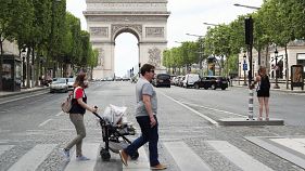 People stroll on the Champs Elysees avenue in Paris