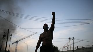 A protester raises his fist during a demonstration Tuesday, June 2, 2020 in Paris.