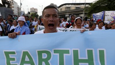 Environmental activists shout slogans as they conclude their caravan from the southern Philippines to mark the global celebration of World Environment Day on  June 5, 2020.