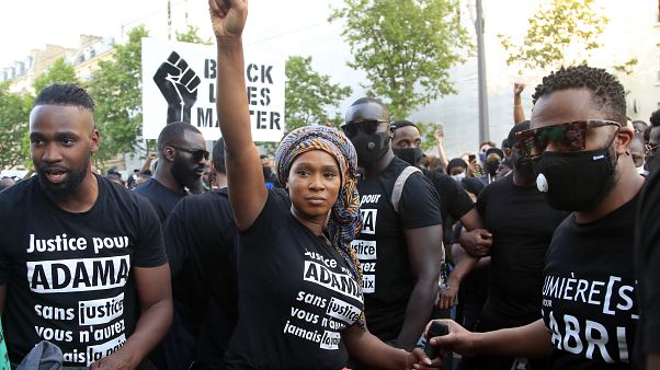 Assa Traore, sister of Adama Traore, raises her fist during a demonstration in Paris. Assa Traore, sister of Adama Traore, raises her fist during a demonstration in Paris.