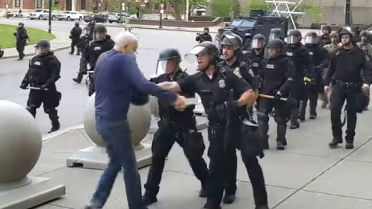 A Buffalo police officer shoves a man who walked up to police Thursday, June 4, 2020, in Buffalo, N.Y.