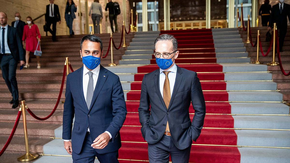 German Foreign Minister Heiko Maas, right, and his Italian counterpart Luigi Di Maio wear face masks 
