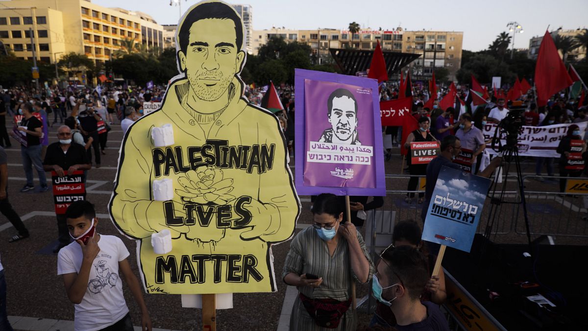 Protesters attenda rally against Israel plans to annex parts of the West Bank, in Tel Aviv, Israel, Saturday, June 6, 2020. 