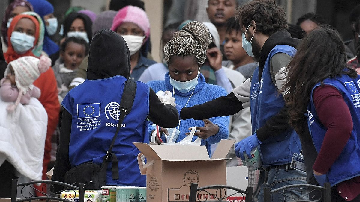 Migrants queue to get sanitisers and other items distributed by the International Organization for Migration (IOM) outside a hotel near Kranidi, Greece, on April 21, 2020