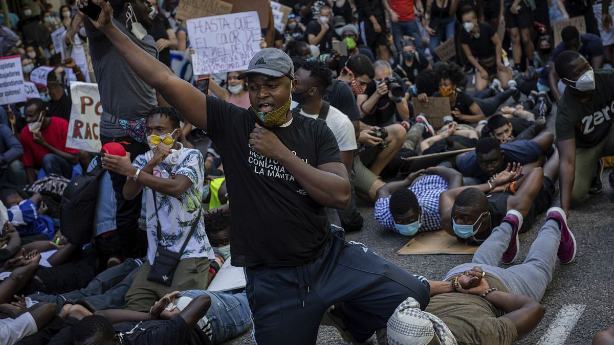 Demonstrators gather in front the American embassy in Madrid, Spain, Sunday, June 7, 2020 during a protest over the death of George Floyd and victims of racial injustice. 