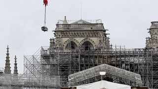 Workers suspended from ropes will be lowered into the charred remains of scaffolding 