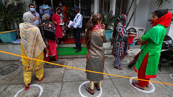 Indians queue up outside a bank to withdraw money during lockdown in Jammu, India, Tuesday, April 7, 2020. Indians queue up outside a bank to withdraw money during lockdown in Jammu, India, Tuesday, April 7, 2020.