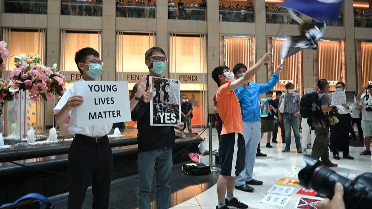 Wide shot student holding 'Young Lives Matter' banner