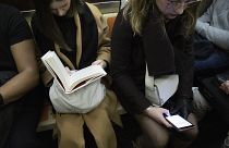 Woman looking at mobile phone on a New York subway