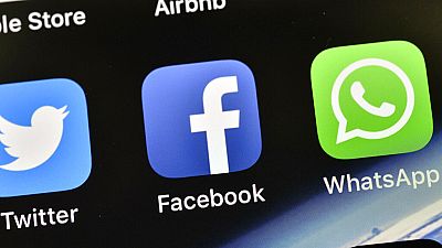n this Nov. 15, 2018, file photo the icons of Facebook and WhatsApp are pictured on an iPhone in Gelsenkirchen, Germany.