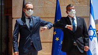 Israeli Foreign Minister Gabi Ashkenazi, right, welcomes his German counterpart Heiko Maas with an elbow bump prior to their meeting in Jerusalem, Wednesday, June 10, 2020