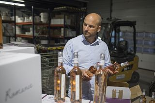 Sebastien Latz, director of French wine producer MDCV, inspects bottles of rosé at Chateau des Bertrands vineyard in Le Cannet-des-Maures, in the Provence region, Oct 2019