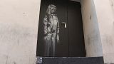 Banksy's artwork on a fire exit of the Bataclan concert hall in Paris - File, June 2018