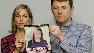 FILE - In this May 2, 2012 file photo, Kate and Gerry McCann hold a poster depicting an age progression computer generated image of their daughter Madeleine.