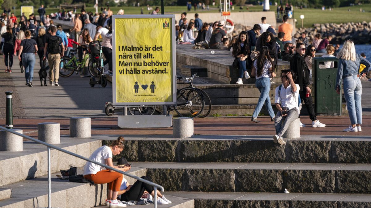 People enjoy the warm evening weather in Malmo, Sweden, Tuesday May 26, 2020. (Johan Nilsson/TT via AP)