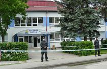 Police officers secure the area after of a shooting at the primary and secondary school in Vrutky, Slovakia, Thursday, June 11, 2020.