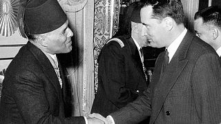 French Justice Minister Francois Mitterrand shakes hands with Tunisian Prime Minister Habib Bourguiba during the Independence celebration in Tunis 20 May 1956