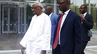 Former president of the IAAF (International Association of Athletics Federations) Lamine Diack, left, arrives at the Paris courthouse, Wednesday, June 10, 2020