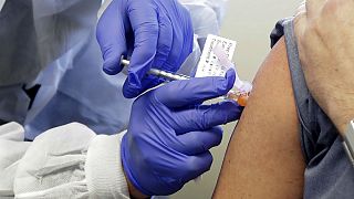 FILE - In this March 16, 2020, file photo, Neal Browning receives a shot in the first-stage safety study clinical trial of a potential vaccine for COVID-19
