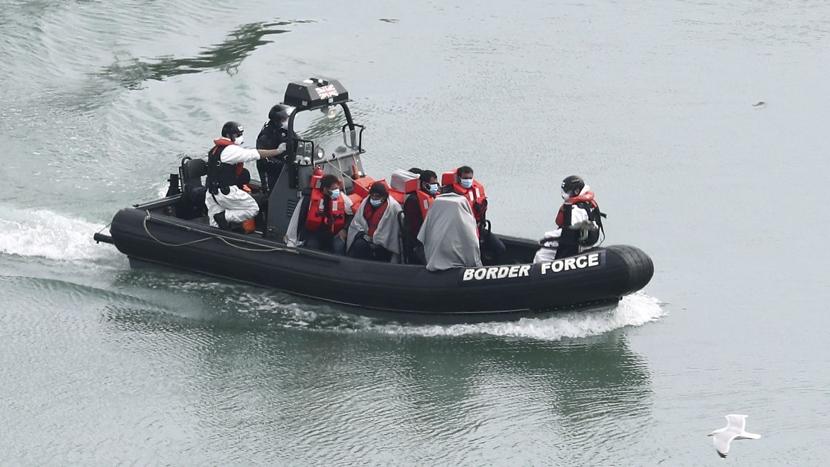A group of people, thought to be migrants are transported on a Border Force vessel, in Dover, England, Monday, April 27, 2020