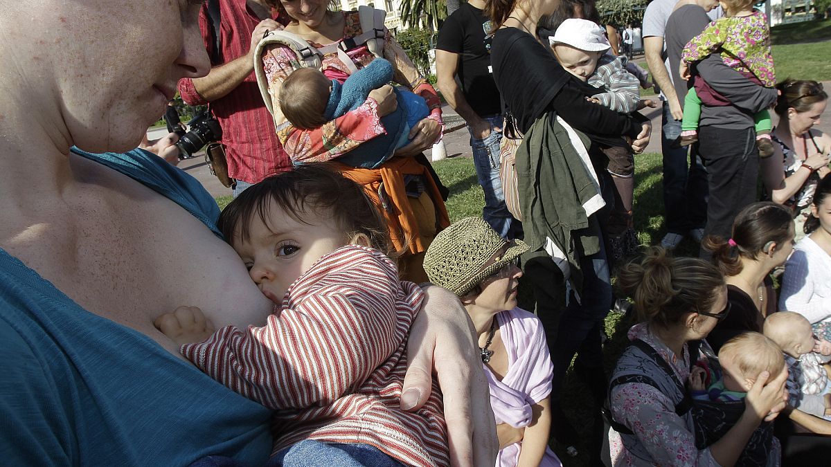 Mothers feed their children during the first day of the 6th World Breastfeeding Week