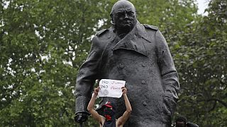 Protesters stand on the statue of former British Prime Minister Winston Churchill during a demonstration in Parliament Square in London on Wednesday, June 3, 2020