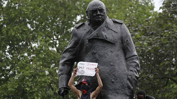 Protesters stand on the statue of former British Prime Minister Winston Churchill during a demonstration in Parliament Square in London on Wednesday, June 3, 2020 Protesters stand on the statue of former British Prime Minister Winston Churchill during a demonstration in Parliament Square in London on Wednesday, June 3, 2020