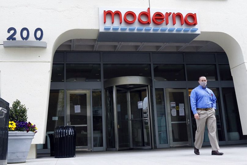 A man stands outside an entrance to a Moderna building in Cambridge, May 2020