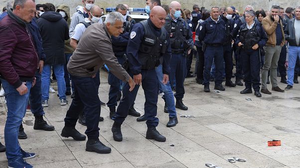 French police throw handcuffs and arm band on the ground following demonstrations against police brutality and racism.
