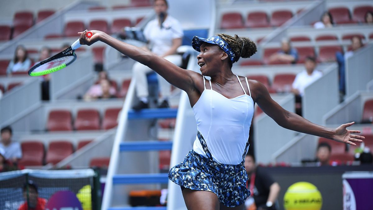 Venus Williams of the US hits a return against Barbora Strycova of the Czech Republic in their women's singles first round match at the WTA China Open tennis tournament.
