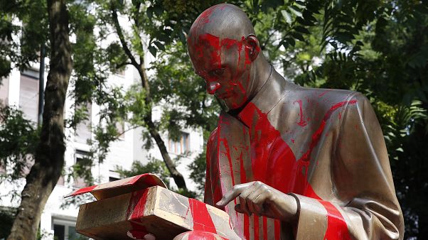 Red paint is seen on a statue of late Italian journalist Indro Montanelli, in Milan, northern Italy, Sunday, June 14, 2020 Red paint is seen on a statue of late Italian journalist Indro Montanelli, in Milan, northern Italy, Sunday, June 14, 2020