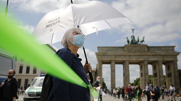 A protestor attends the 'This is solidarity' demonstration of the Indivisible movement, in Berlin, on June 14, 2020. A protestor attends the 'This is solidarity' demonstration of the Indivisible movement, in Berlin, on June 14, 2020.