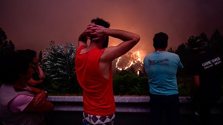 Villagers stare at the flames in despair during the 2017 deadly wildfire near Pedrógão Grande, Portugal