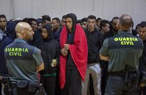 Guardia Civil officers stand guard in June 2018 as migrants stay at a makeshift emergency center in the south of Spain, after being rescued by Spain's Maritime Rescue Service.