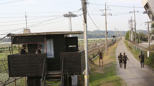 South Korean army soldiers patrol along the barbed-wire fence in Paju, South Korea, near the border with North Korea South Korean army soldiers patrol along the barbed-wire fence in Paju, South Korea, near the border with North Korea